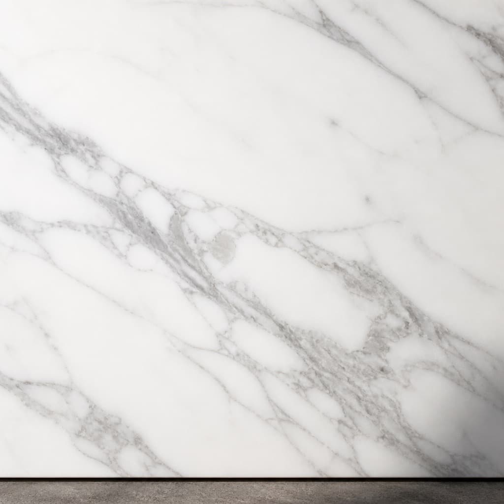 A honed Carrara marble tile filling the frame, grey veining running diagonally across a cool white surface